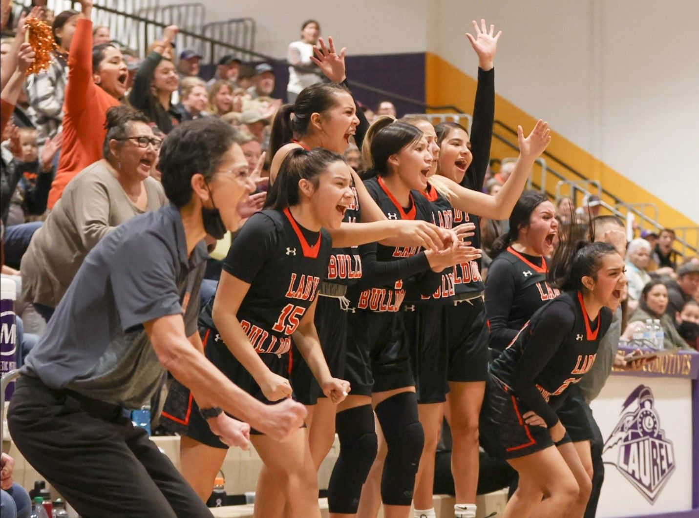 The bench reacts after a Bends three-point play. / Photo by Tommy Robinson