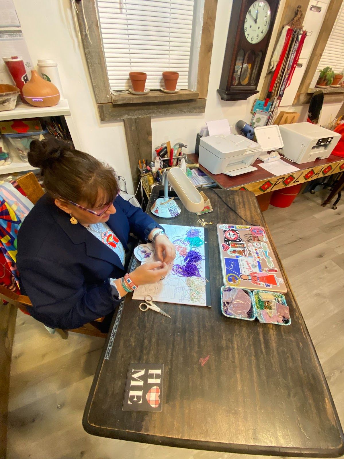 Carrie McCleary works on a beaded piece for her Plains Soul Collection. / Photo by Rusty LaFrance, Four Points Press