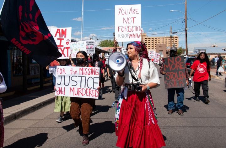 Kara Plummer uses a bullhorn for call and response with demonstrators marching through Old Town calling for justice for missi