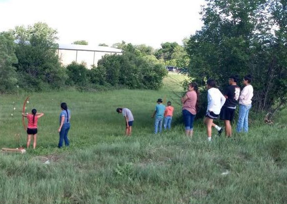 Crow children practice with bows and arrows in preparation for the first Youth Ultimate Warrior, which takes place at 9 a.m.