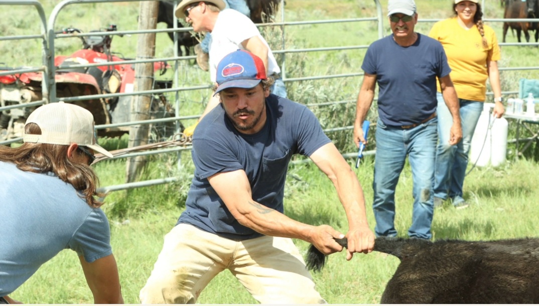 Victor Three Irons would regularly help out his family. Here, he helps wrangle a calf at his maternal family’s ranch during o