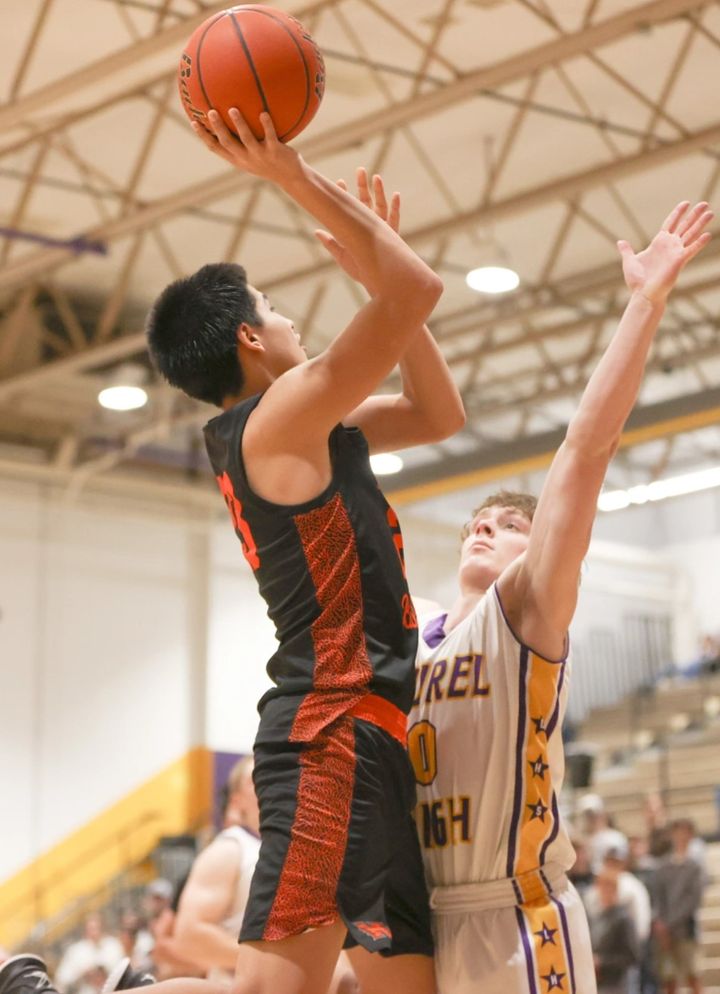 Troy Hugs looks to make a running shot over the Laurel defense. / Photo by Tommy Robinson